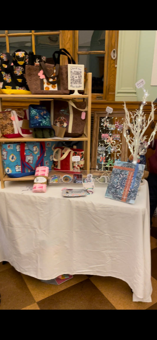 our market booth at our latest market with our paperless towels, earrings, coloring books, drying mats and our purses. 